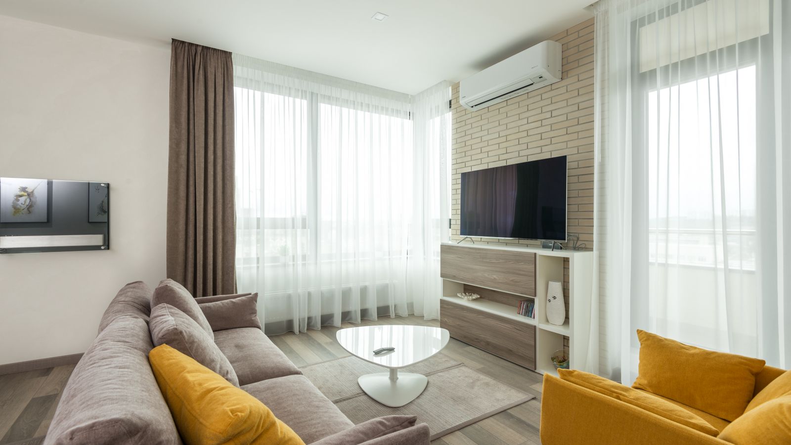 Wall-mounted air conditioning unit installed in a bright living room